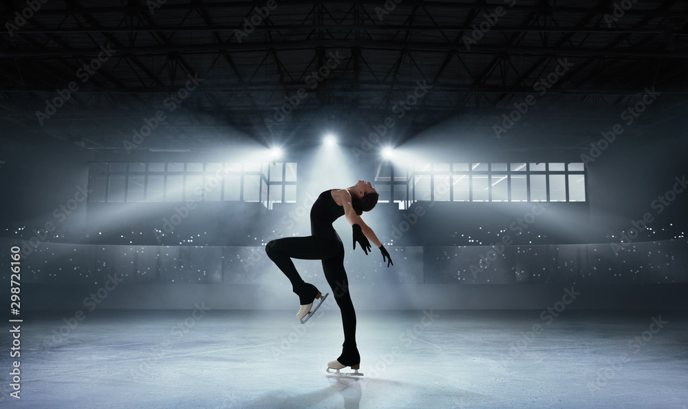 Figure skating girl in ice arena.