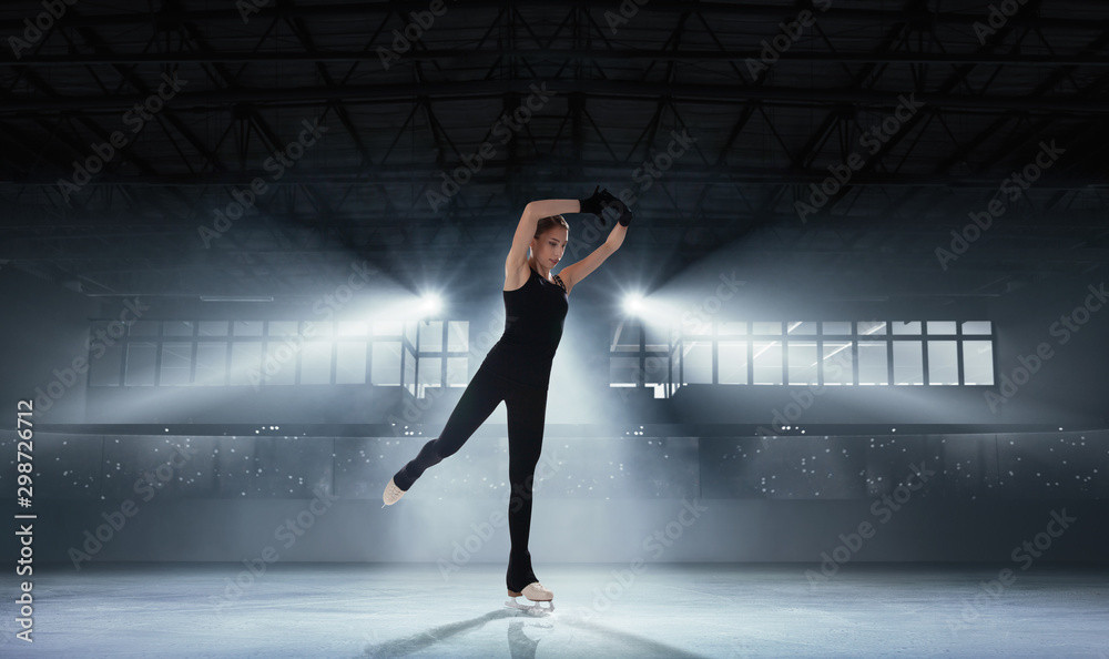 Figure skating girl in ice arena.