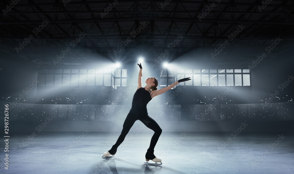 Figure skating girl in ice arena.