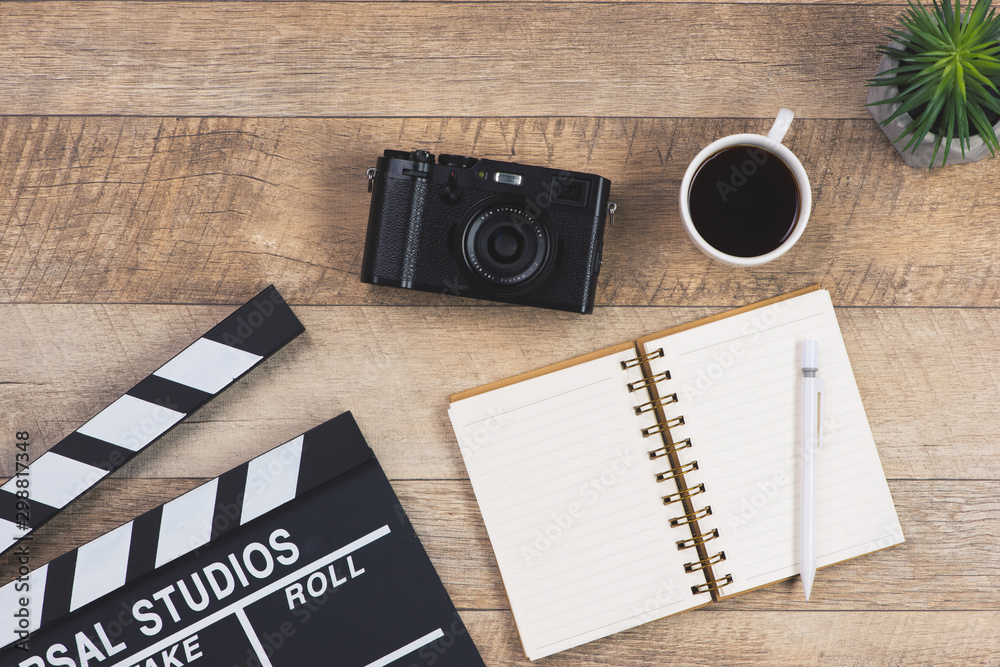 film directors desk on wood background. top view shot