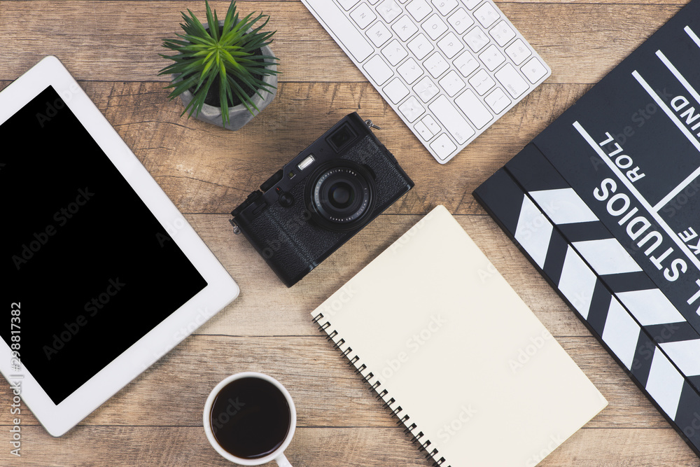 film directors desk on wood background. top view shot