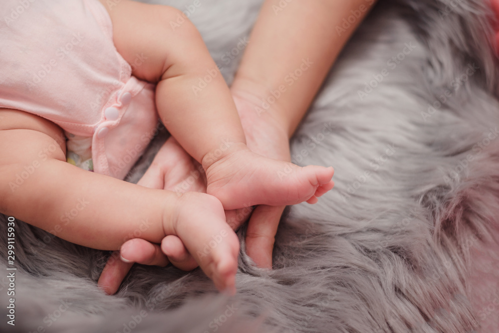 Baby feet in mother hands. Mom and her Child. Happy Family concept. Beautiful conceptual image of Ma