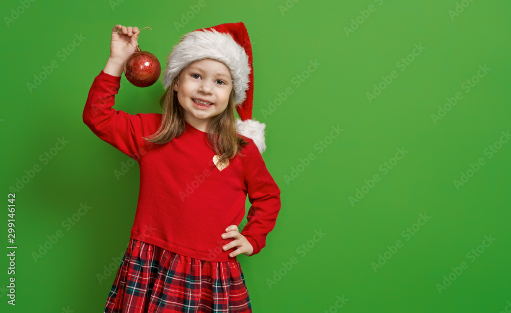 girl in Santa hat on color background