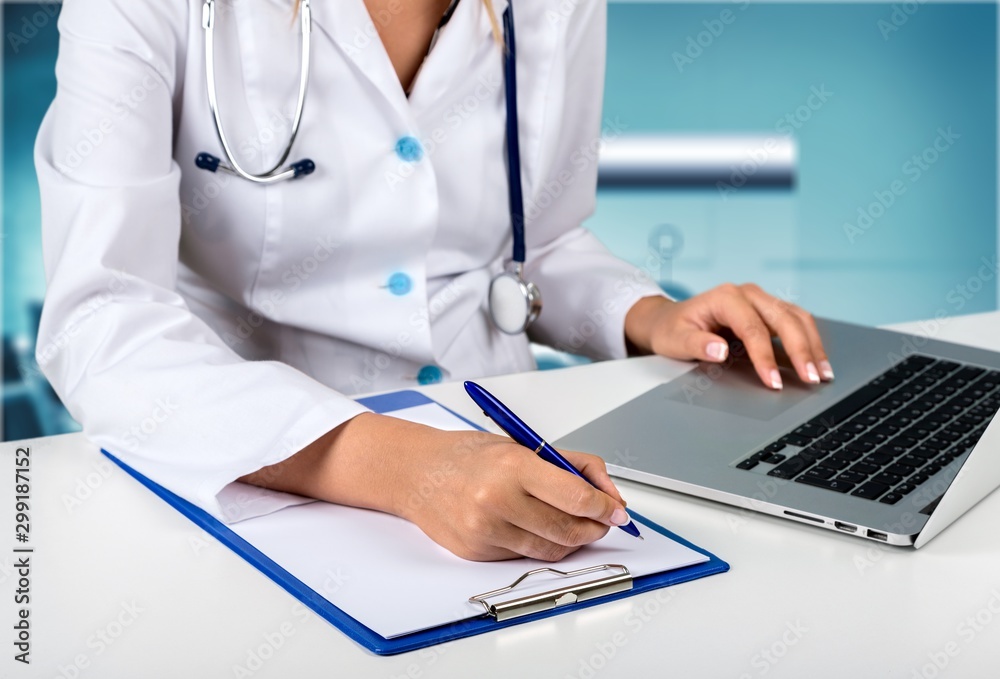 Close-up Doctor at hospital working with laptop