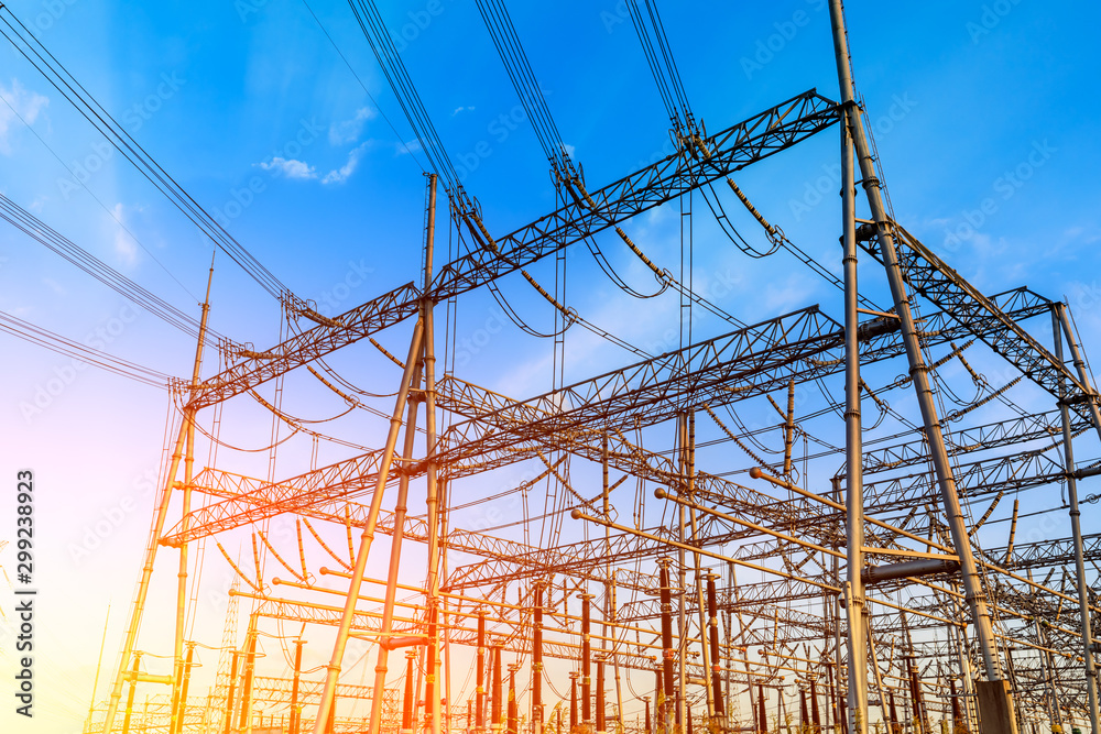 High voltage electricity tower at sunset.substation industrial background.