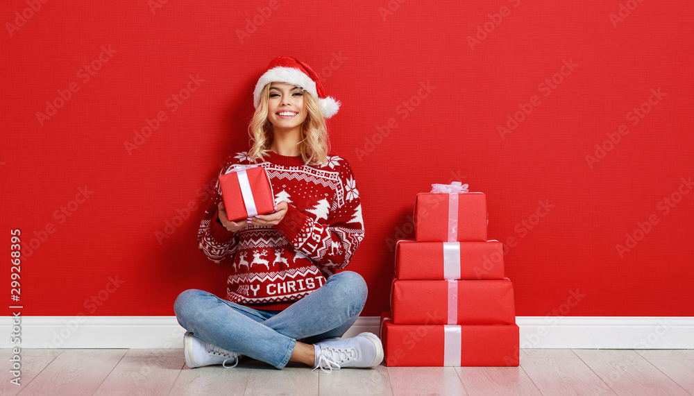 happy   girl gets ready for christmas and packs gifts.