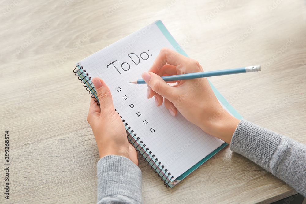 Woman making to-do list at table