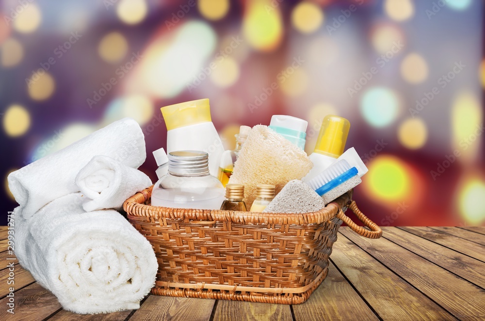 Bath towel and basket with accessories for spa on blur background