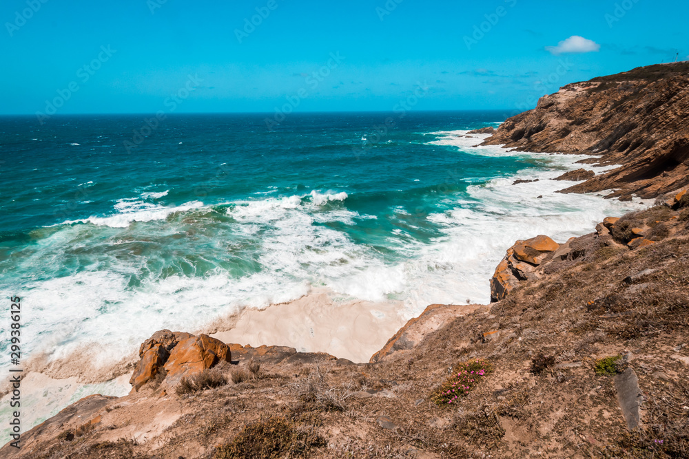 The Indian Ocean and waves breaking on the shore near Cape Agulhas, the southernmost point in Africa