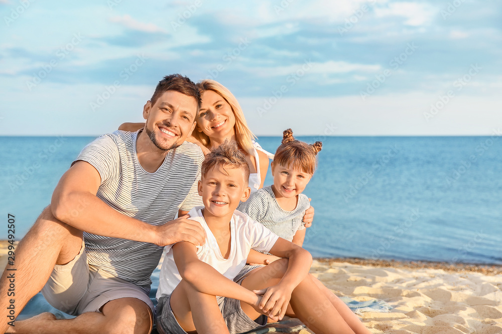 Portrait of happy family on sea beach