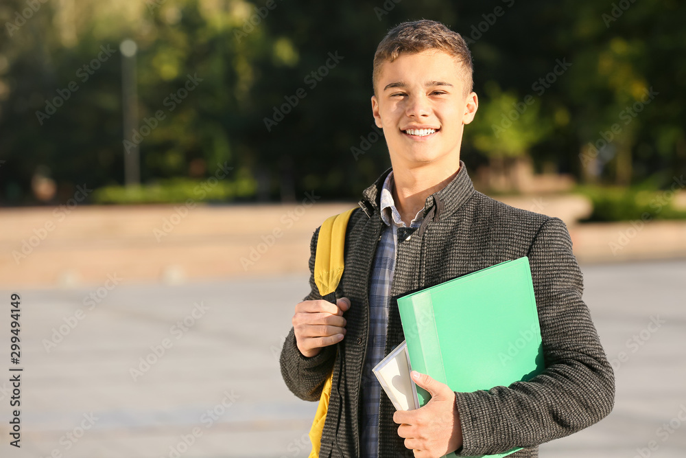 Portrait of teenage male student outdoors