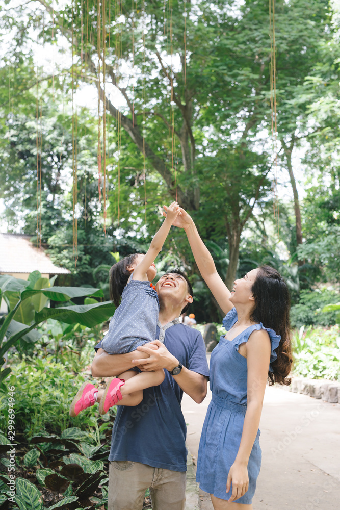 Happy young couple spending time with their daughter