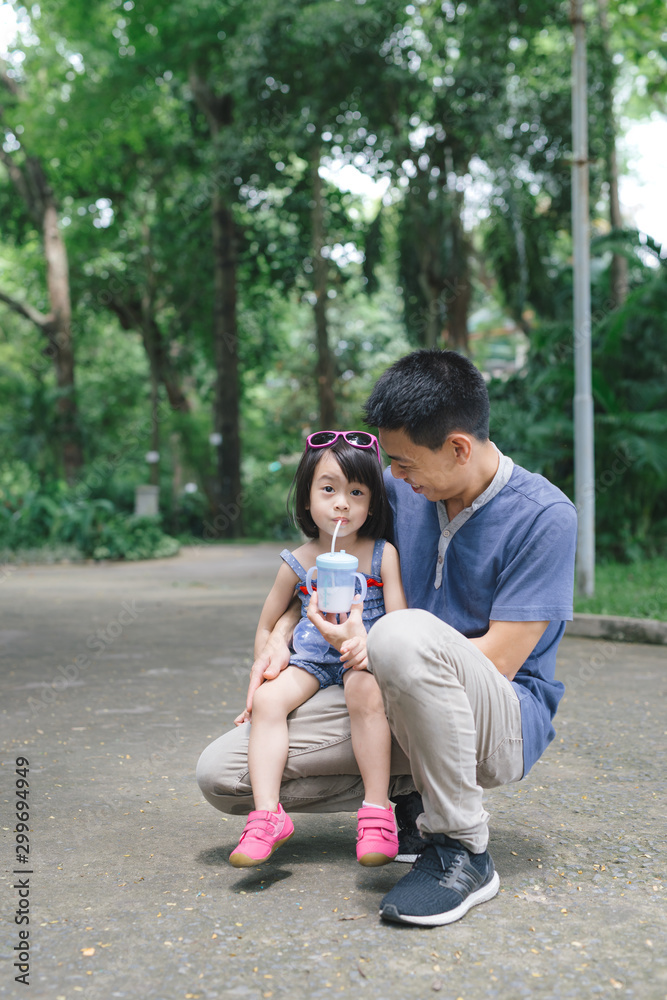 Portrait of little girl hugging her daddy with nature, family concept