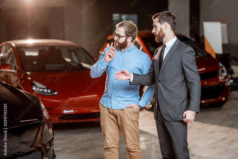 Client with a salesman at the showroom with electric cars