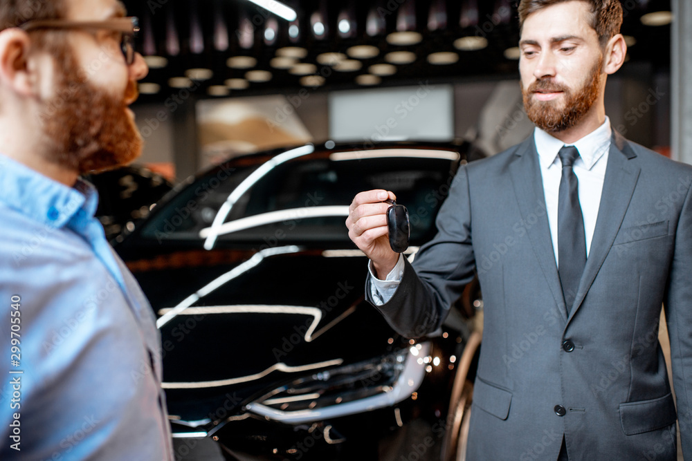 Client with a salesman at the showroom with electric cars