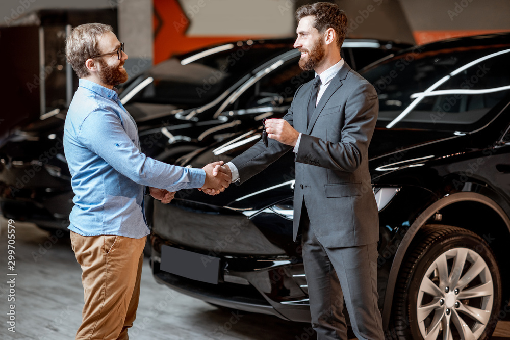 Client with a salesman at the showroom with electric cars