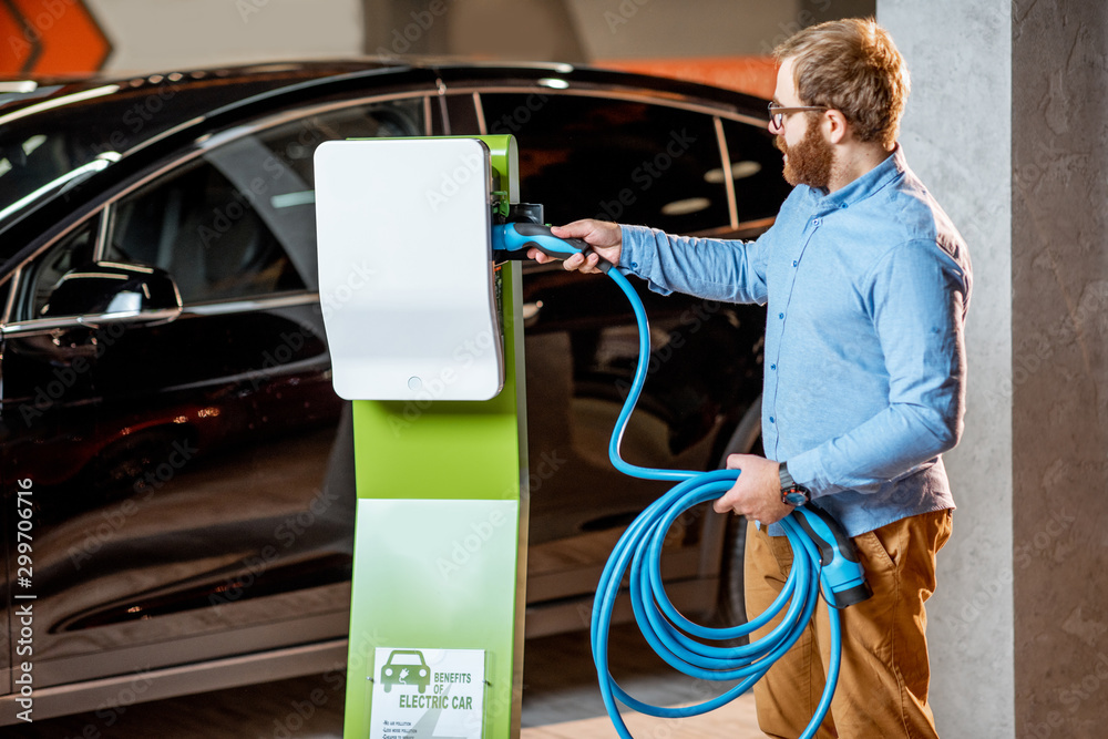 Man buying electric charger at the car dealership