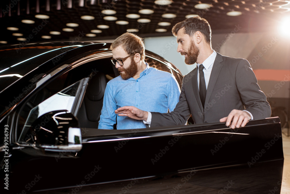 Client with a salesman at the showroom with electric cars