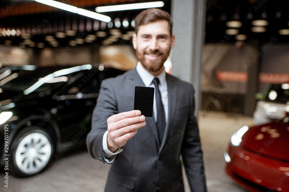 Salesman with key at the car dealership