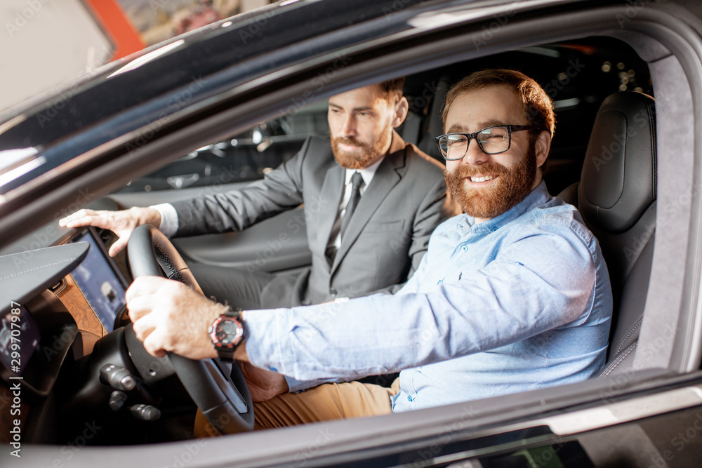 Sales manager with a client looking at the vehicle interior