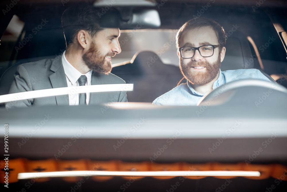 Sales manager with a client looking at the vehicle interior