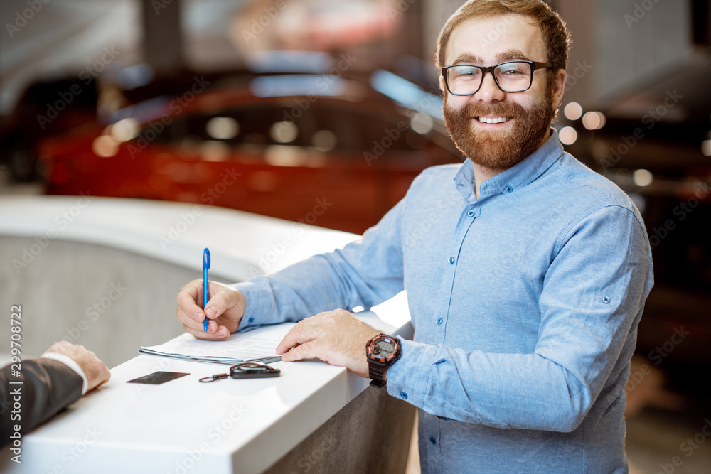 Man buying a new car at the dealership