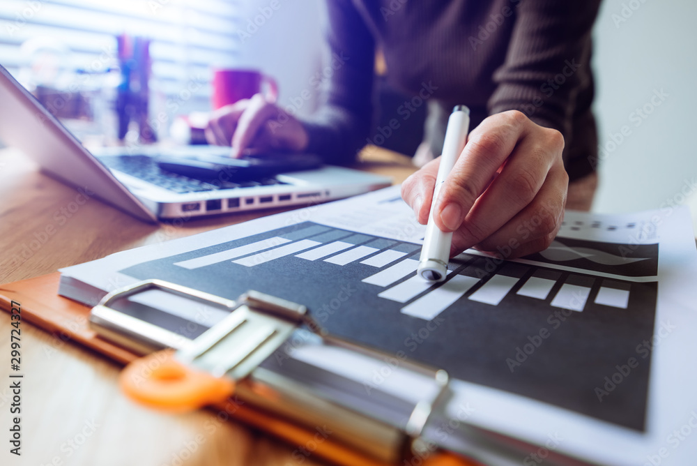 businessman hand working with new modern computer and writing on the notepad strategy diagram as con