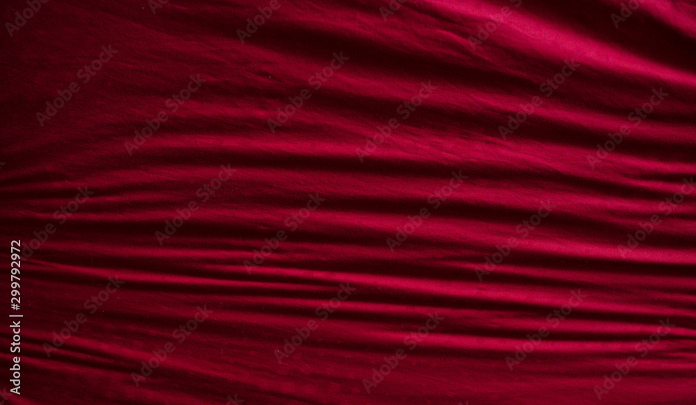 Top view of a red messy bedding sheet after night sleep.