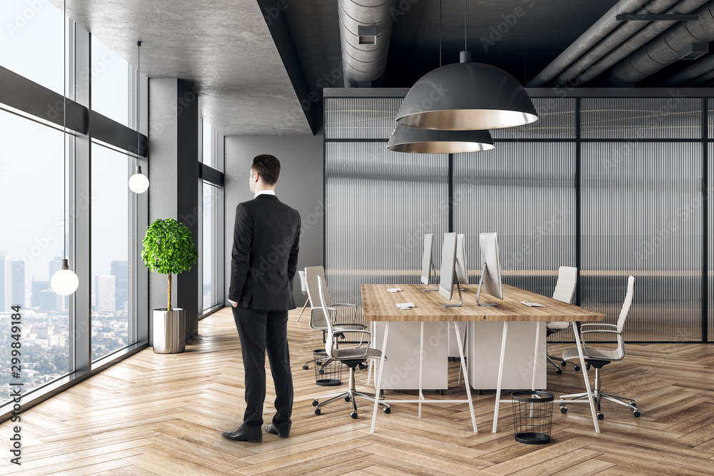 Businessman in minimalist coworking office interior