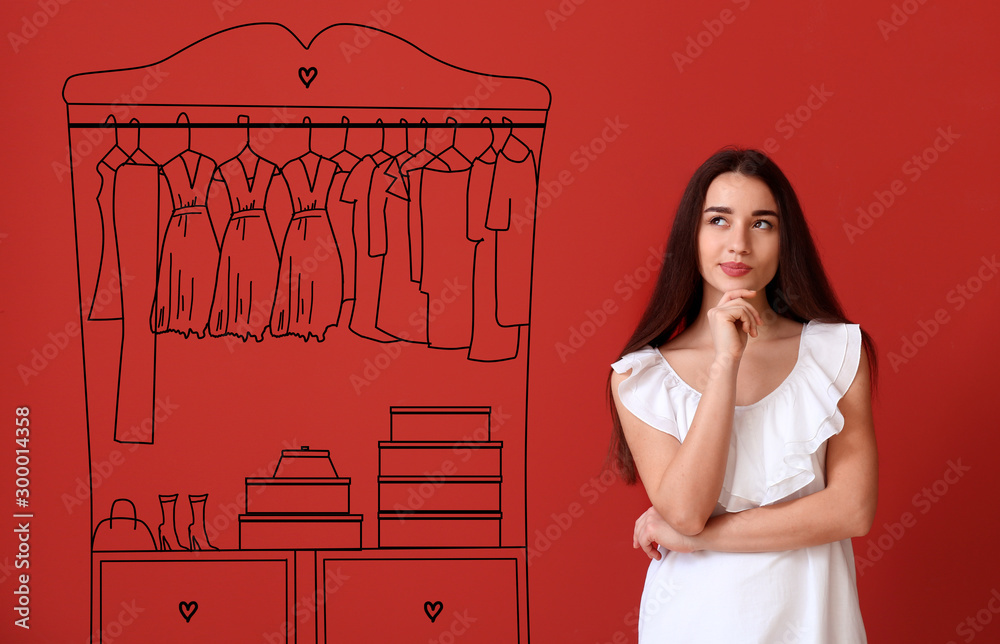 Thoughtful young woman imagining interior of dressing room