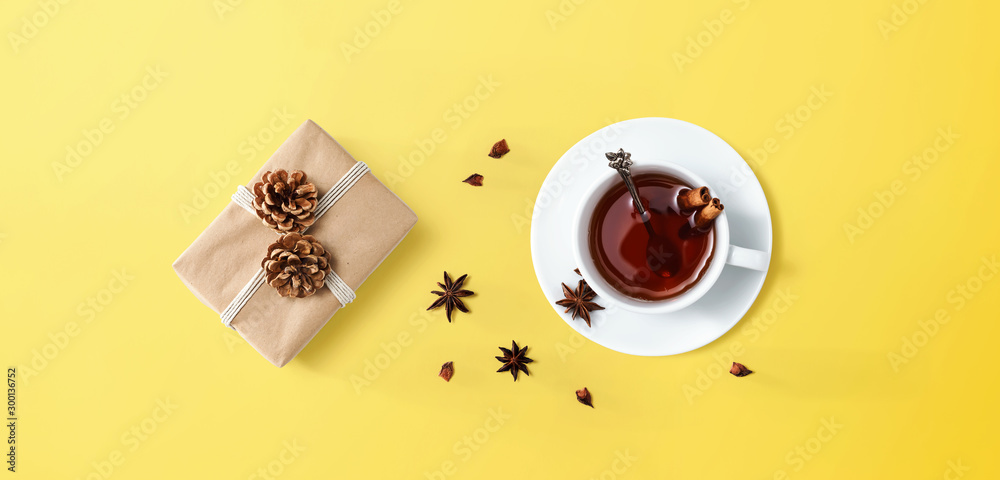 Cup of tea with a gift box - overhead view flat lay