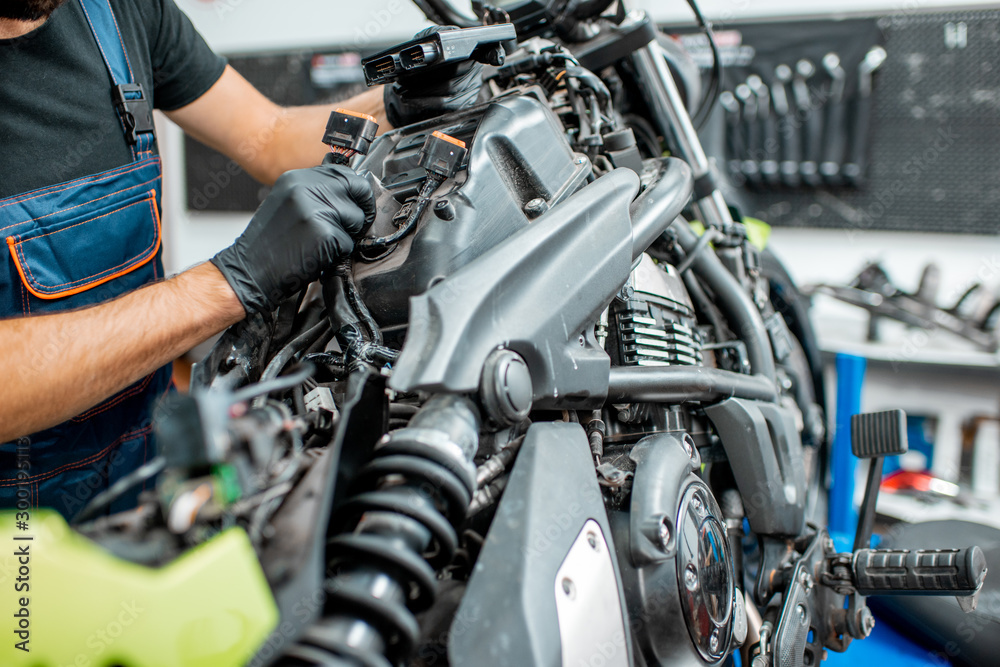 Electrician repairing motorcycle wiring