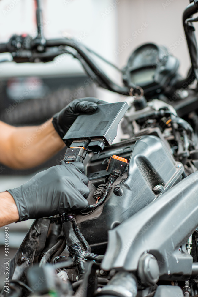 Electrician repairing motorcycle wiring