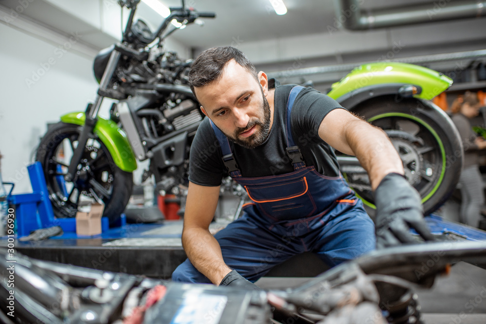 Biker with motorcycles in the garage