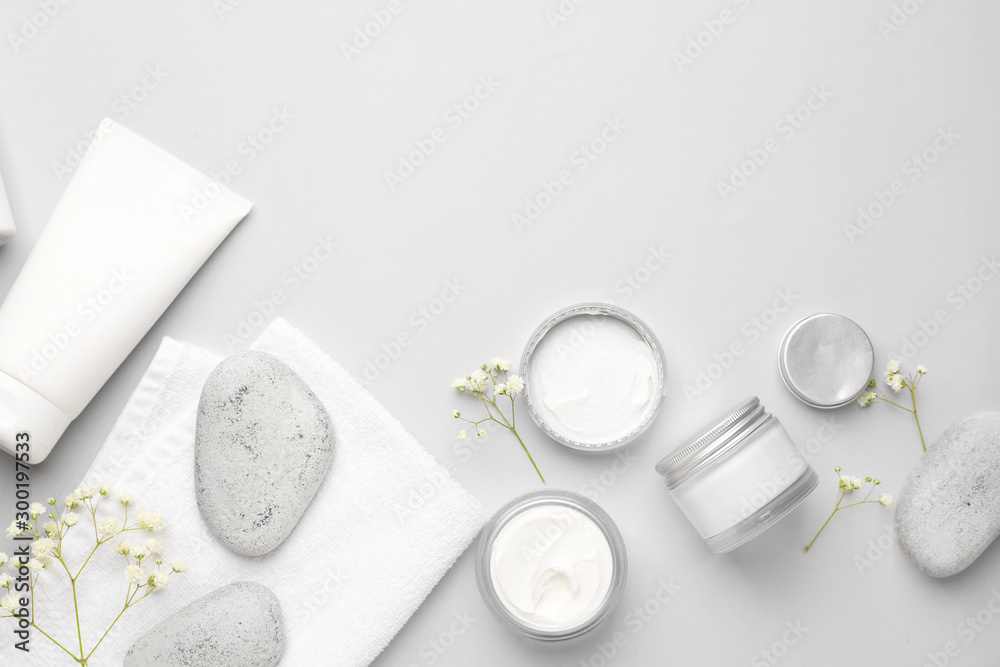 Cosmetic cream with spa items on white background