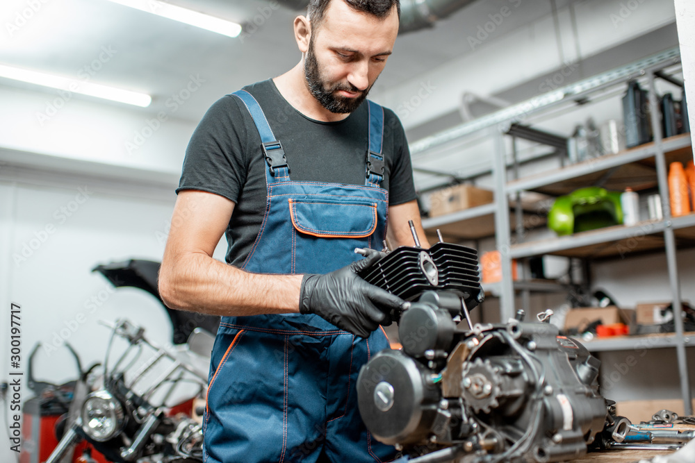 Man repairing motorcycle engine