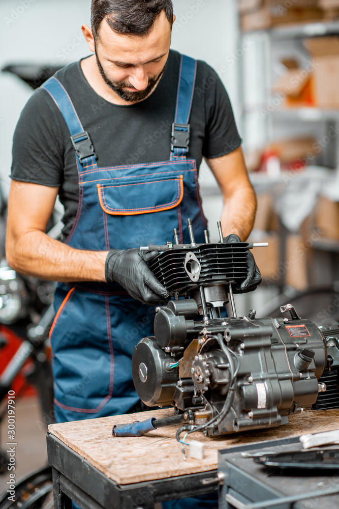 Man repairing motorcycle engine