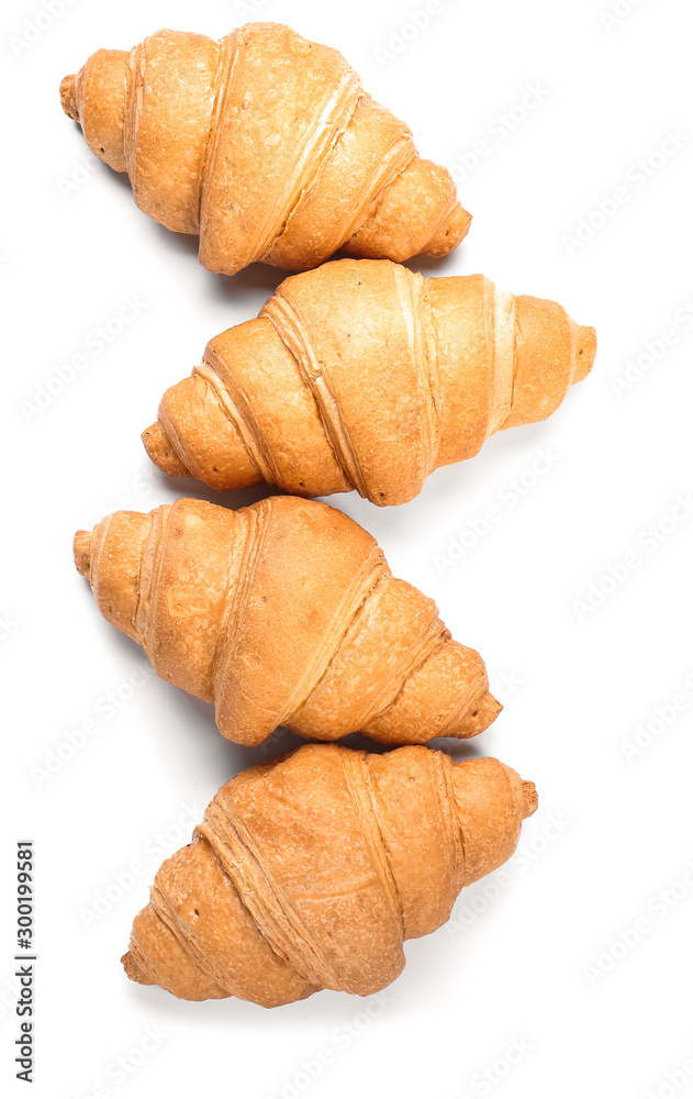 Sweet tasty croissants on white background