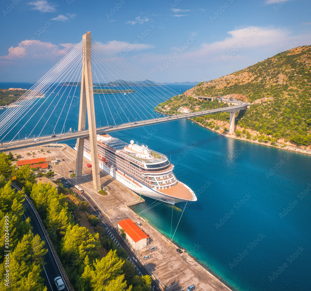 Aerial view of cruise ship and beautiful bridge in Dubrovnik, Croatia. Top view of large ship and ro