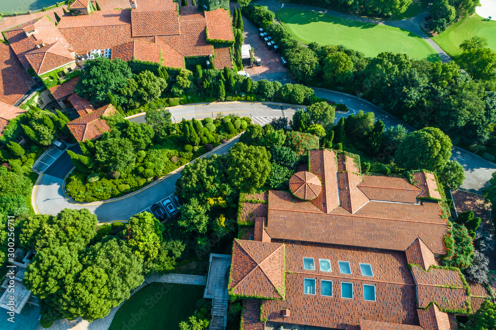 Aerial view of a beautiful green golf course with residential architecture.