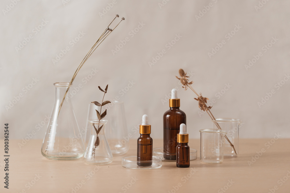 Cosmetic bottle stock images. Brown cosmetic bottle with batcher. Vials on a white background