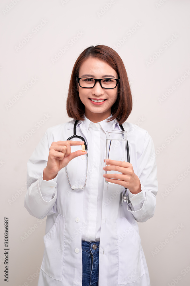 Doctor woman holding water and medicine on white background