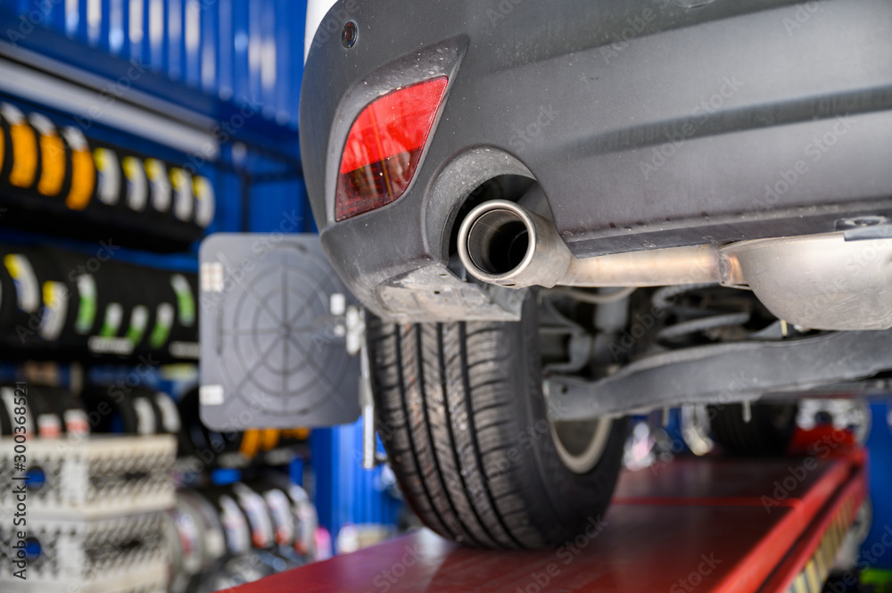 Wheel alignment, car on stand aligning for new tire replacement