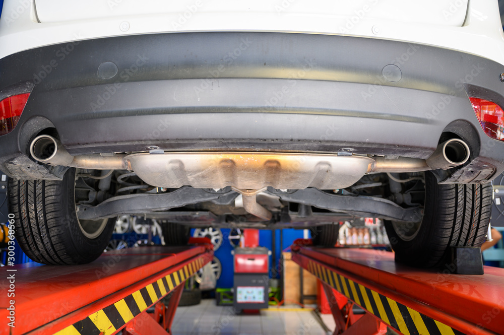 Wheel alignment, car on stand aligning for new tire replacement