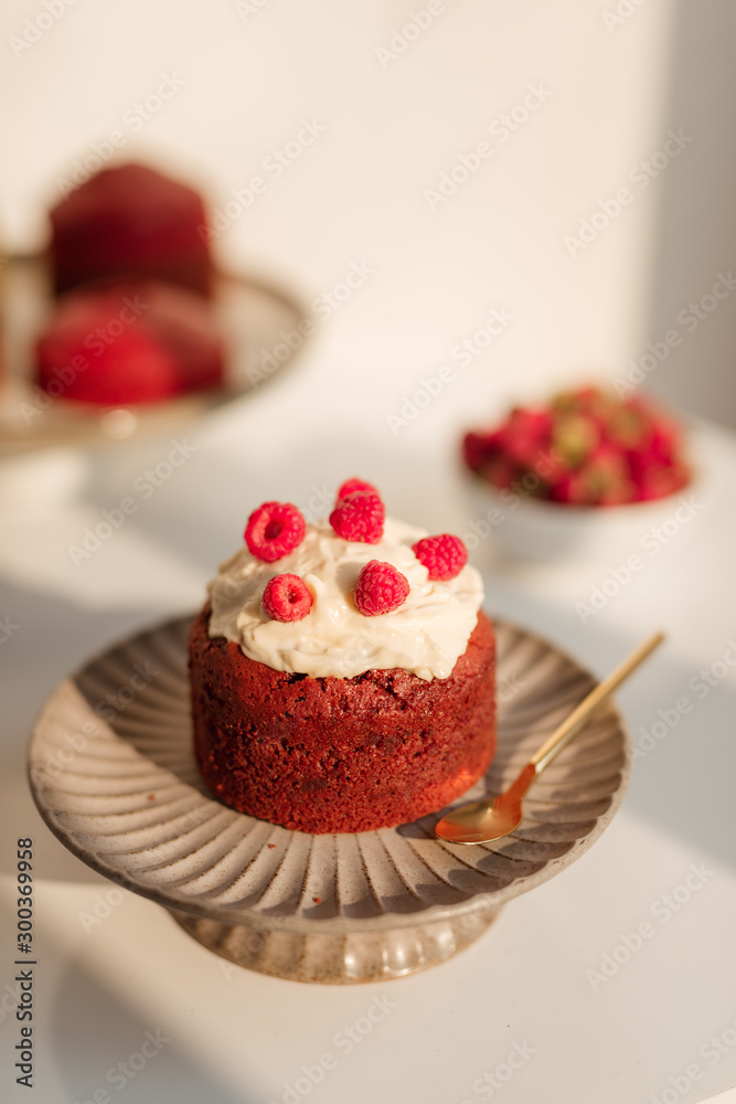 Delicious cupcakes with berries on stand over white background