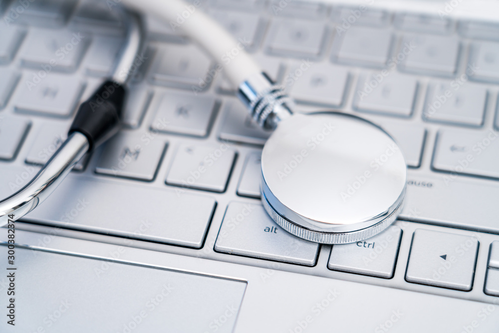 Stethoscope on a silver computer keyboard - health care concept picture