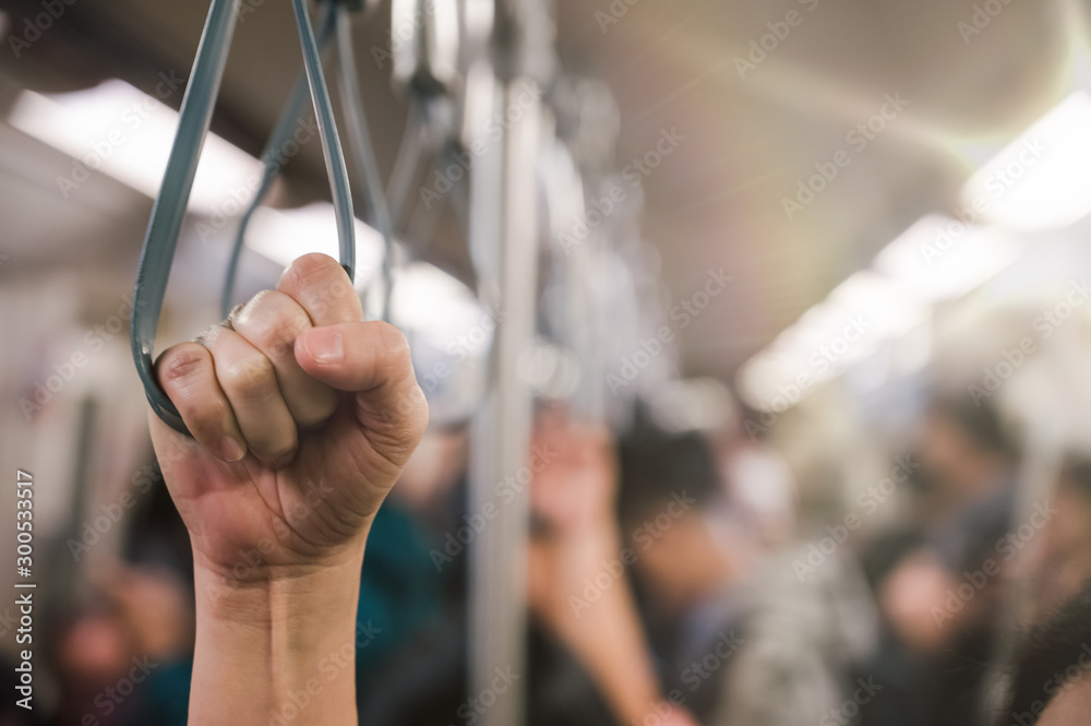 young passenger woman hand holding Handle on the train or on the bus for safety. Safety travel trip,