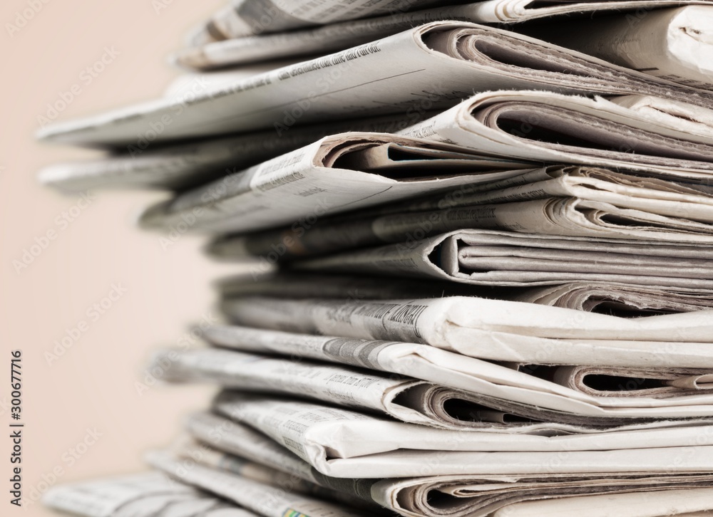 Pile of newspapers on background, close-up view