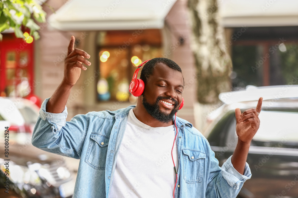 Handsome African-American man listening to music outdoors