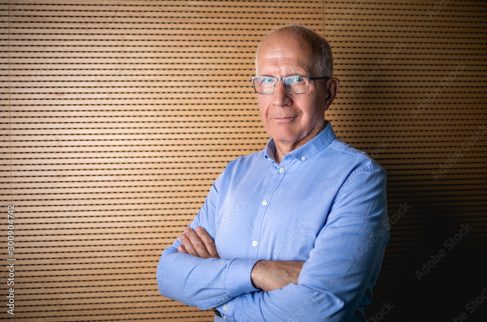 Portrait of senior businessman with eyeglasses looking at camera